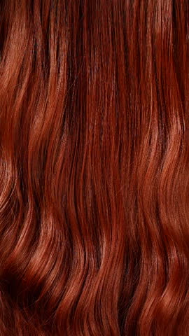Vertical blond hair texture, slow motion of female hand combing long curly hair