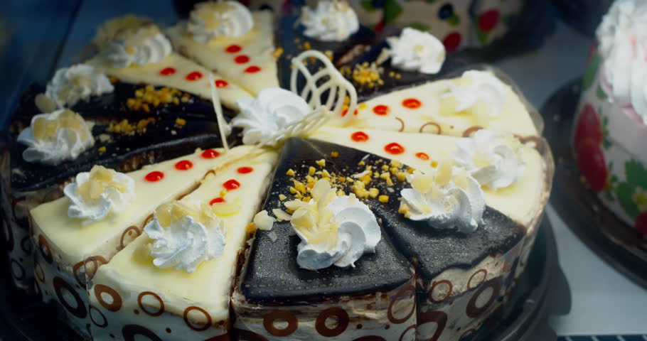 Beautiful cakes are on display. Shoot of Confectionery through the glass of the display case. Close-up.