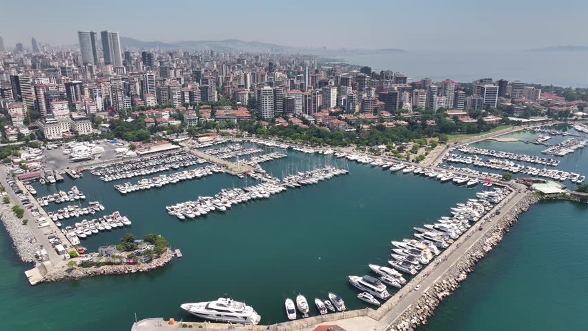 Aerial view of an Istanbul marina with yachts, sailboats, green spaces, and modern city buildings, oe01