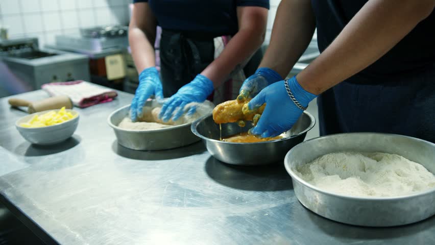 Preparing traditional dishes in a bustling kitchen with skilled cooks at work