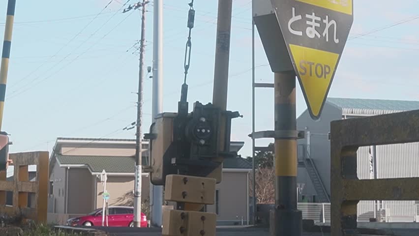 Hitachinaka, Ibaraki, Japan - February 2 2025
Timelapse of a railway crossing with passing cars and flashing signals in a rural setting.
