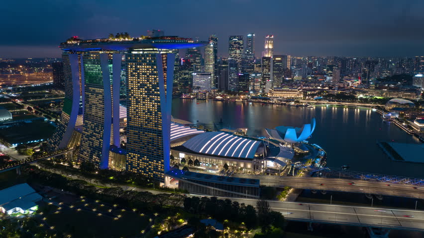 twilight sky illumination singapore city famous downtown hotel marina bay aerial panorama 4k timelapse