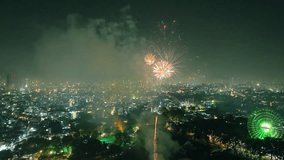 Beautiful aerial view of festive fireworks showing Ho Chi Minh city in Vietnam during Lunar New Year's Eve 2025 with fireworks shooting up and colorful lights on houses. Night celebration - Powered by Shutterstock - Get 15% off with code: PIKWIZARD15