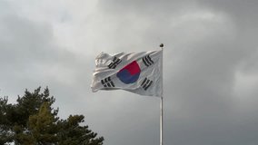 Taegukgi, South Korea national flag is waving on a cloudy day. - Powered by Shutterstock - Get 15% off with code: PIKWIZARD15