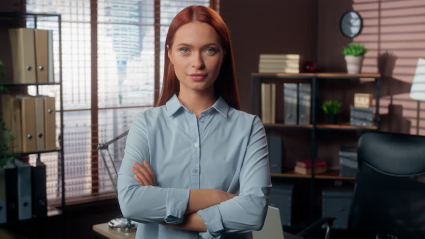 Confident Caucasian business woman girl female businesswoman employer entrepreneur manager company worker bank consultant in office crossed hands folded arms on chest confidence looking at camera