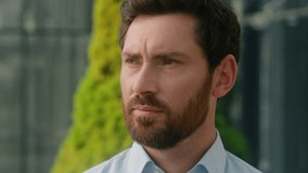 Close up pensive thoughtful Caucasian middle aged adult 40s man thinking looking away ponder male guy business employer businessman face think turn head to camera smiling in city outdoors portrait - Powered by Shutterstock - Get 15% off with code: PIKWIZARD15