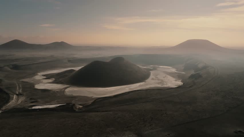 Aerial view from a drone of the black cone of Meke Lake crater with a black earth landscape in Turkey