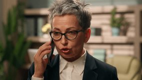 Shocked business trouble conflict quarrel Caucasian senior woman middle-aged businesswoman mature female in office talking arguing mobile phone bad news problem discuss angry argument smartphone call - Powered by Shutterstock - Get 15% off with code: PIKWIZARD15