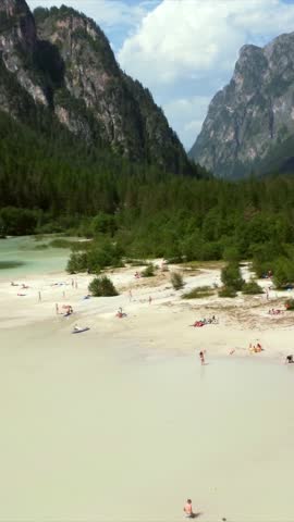 Tourists enjoying summer at lago di landro, also known as durrensee lake, surrounded by the stunning dolomites mountain range in trentino alto adige, italy