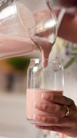 Hands, woman and smoothie in glass at house of healthy drink, nutrition protein and fruit shake. Closeup, blender and organic ingredients with diet weight loss, breakfast juice and digestion benefits