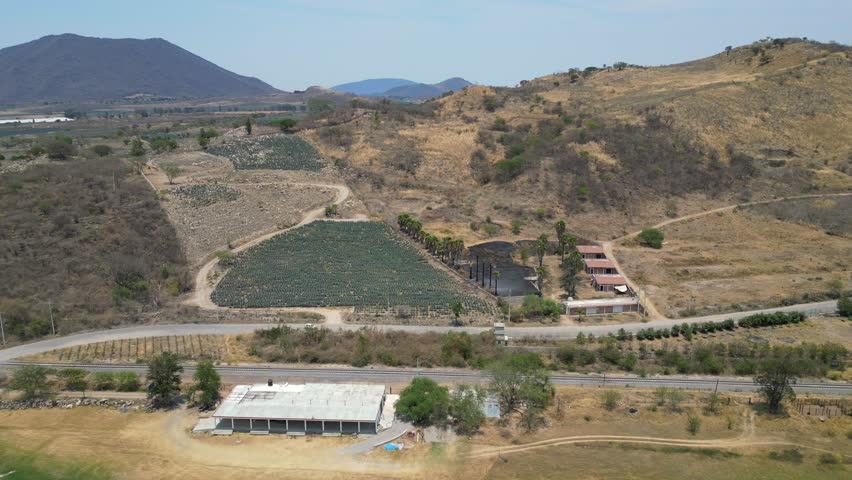 Side view of the road and train tracks next to Valencia Dam in Jalisco, Mexico. A serene countryside landscape