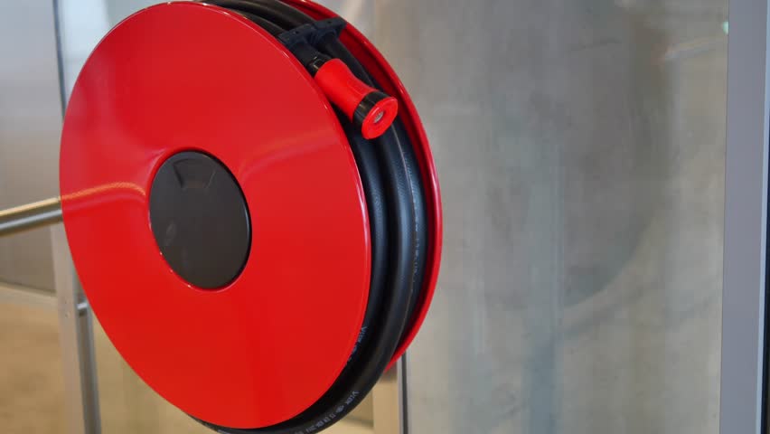 Fire hose reel mounted on wall for quick emergency access