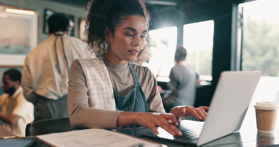 Woman, laptop or thinking in restaurant startup for planning, menu design or budget management. Small business owner, tech or reading in cafe for stock control, invoice payment or shift list schedule