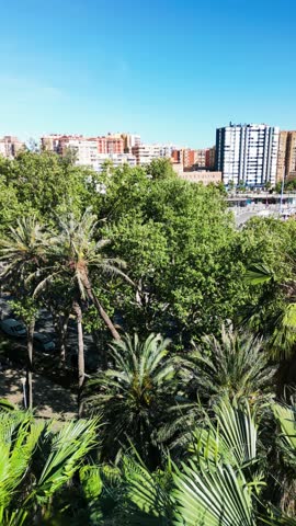 Stunning aerial view of Malaga with coastline, cityscape, and mountains in the background