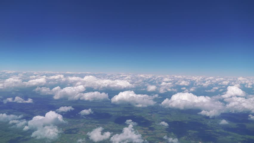 Soaring High Above Beautiful Fluffy Clouds on a Sunny Day in 4k