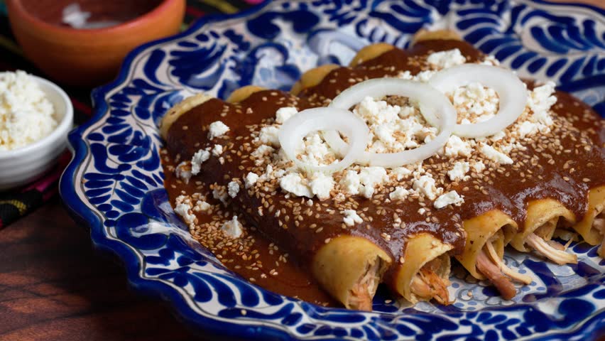 Mexican food, Enmoladas or chicken mole enchiladas, macro view
