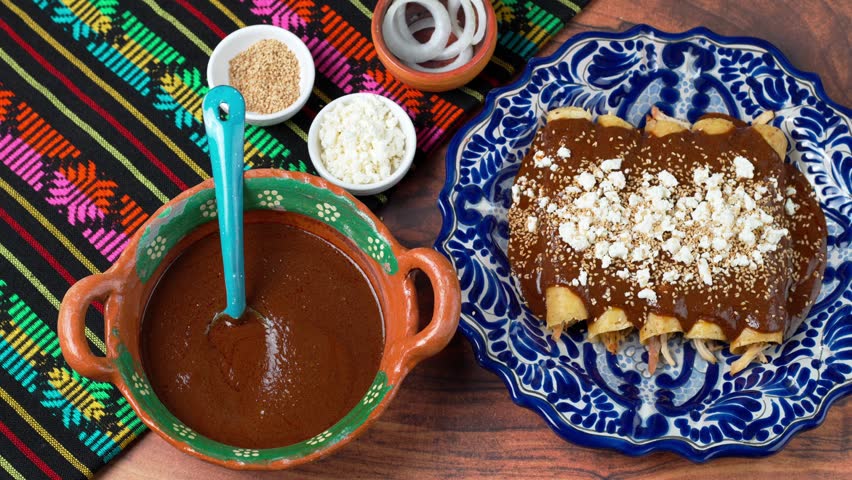 Mexican woman prepares chicken mole enchiladas decorated with onion slices