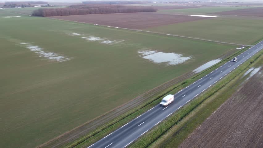 Aerial view of a departmental road, with low traffic, in the French countryside