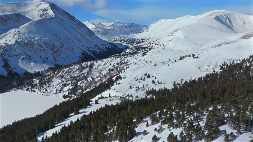Hoosier Pass winter wilderness nature backcountry Breckenridge Colorado aerial drone Quandary Peak Alma Fairplay Blue River Rocky Mountains morning blue sky 14er December January forward pan up motion