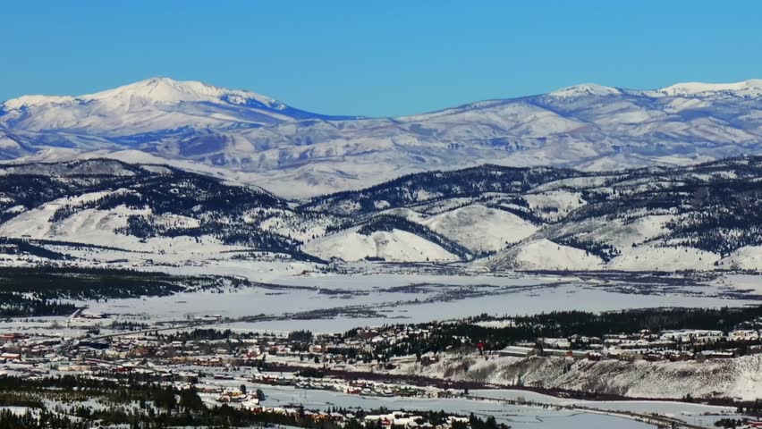 Rocky Mountain National Park entrance Fraser Grandby downtown Winter Park ski resort mountain town aerial drone ColoradoGrand Lake winter December snow blue sky cars Main Street sunny pan left motion