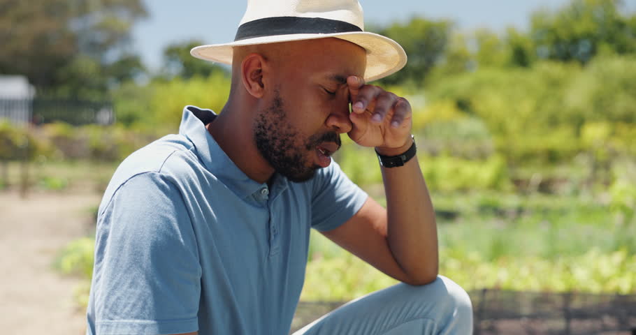 Tired man, farmer and harvest with agriculture or stress for overworked, burnout or fatigue in countryside. Frustrated, exhausted or male person in heat wave for crops, natural growth or conservation