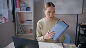 Smart tutor explaining online lesson pointing tablet screen at classroom closeup. Serious woman teacher talking remotely looking laptop at cabinet. Young professor communicating virtual chat meeting - Powered by Shutterstock - Get 15% off with code: PIKWIZARD15