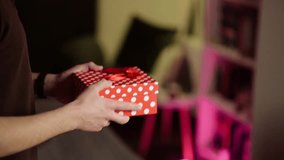 A man gives a gift to his girlfriend for Valentine's Day or anniversary - Powered by Shutterstock - Get 15% off with code: PIKWIZARD15