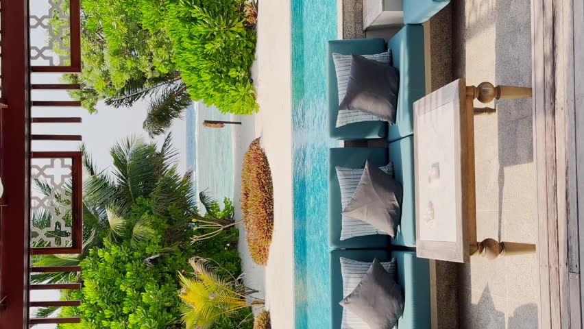 A private beach in the courtyard of a huge luxury villa with a private pool and water slide on a clear sunny day, a paradise for relaxation and vacation