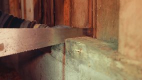 A Person Carefully Saws Through a Wooden Plank in the Barn With Precision. - Close Up - Powered by Shutterstock - Get 15% off with code: PIKWIZARD15