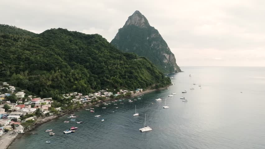 Soufriere Saint Lucia drone shot of Petit Piton over the Caribbean Sea with boats on the water along the coast