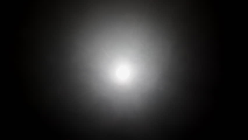 Bright spotlight shining in dark room with haze, Circular bright spotlight creating a halo effect in the darkness