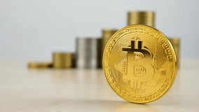 Bitcoin coin in sharp focus with metallic stacks in background. Contrast between digital currency and physical money. Financial transformation, crypto trading, and online assets - Powered by Shutterstock - Get 15% off with code: PIKWIZARD15