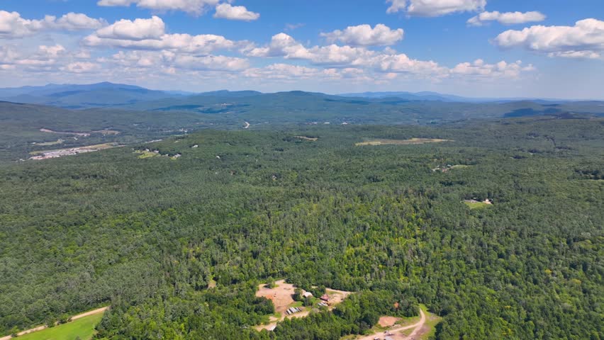 Aerial view the Plymouth rural landscape near Tenney Mountain in summer with White Mountain National Forest at the background in town of Plymouth, New Hampshire NH, USA. 