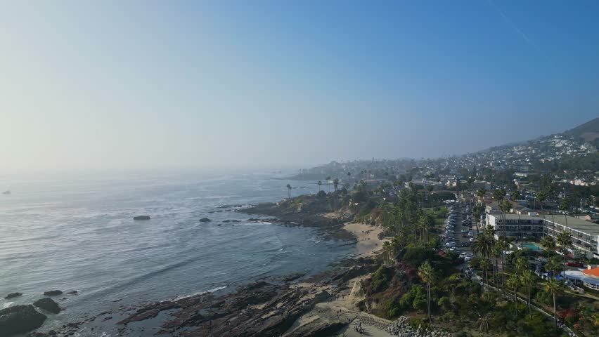 A breathtaking drone reveal shot of Laguna Beach, showcasing the stunning coastline and vibrant scenery of the California coast.