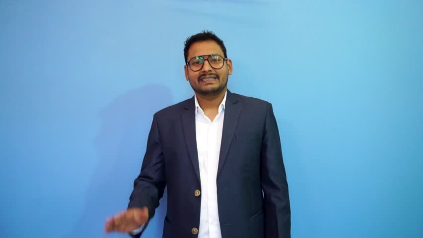 businessman waving his hand and watching towards the camera.