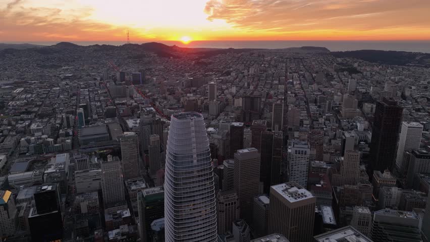 Bright, orange sunset sky over sprawling urban cityscape, San Francisco, California