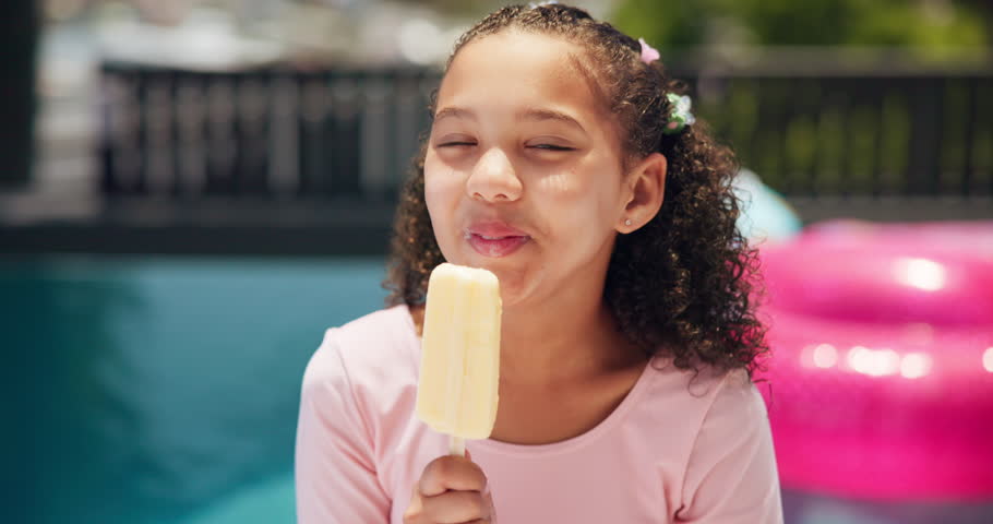 Eating, ice cream or face of girl by pool for summer, holiday or travel in hotel for outdoor tourism. Relax, lick, portrait of child with vanilla sucker, popsicle or frozen snack on weekend vacation