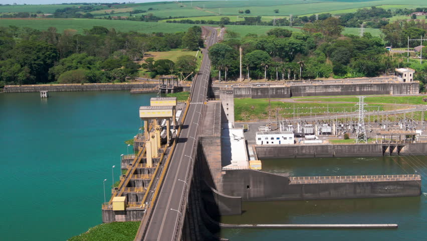Drone aerial landscape of hydroelectric power plant station facility dam water inlet channel wall turbines generator Brazil infrastructure renewables industry buildings.