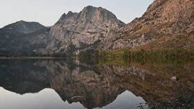 An early autumn sunrise, with the sunlight hitting the mountain and slowly moving down as the sun rises. Silver Lake in the Mammoth Lakes, Eastern Sierras, California - Powered by Shutterstock - Get 15% off with code: PIKWIZARD15