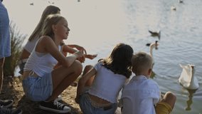 Family feeding ducks and geese by the lake - Powered by Shutterstock - Get 15% off with code: PIKWIZARD15