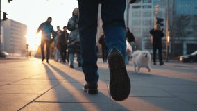 Back view following male feet steps walking pedestrian crossing street on sunny autumn day. Man wearing leather boots goes crossroad. Low angle people legs stepping backlit warm sunlight - Powered by Shutterstock - Get 15% off with code: PIKWIZARD15