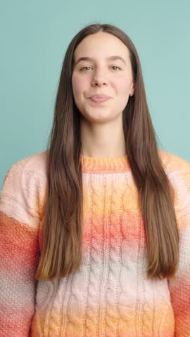 Smiling woman giving thumbs up in positive gesture