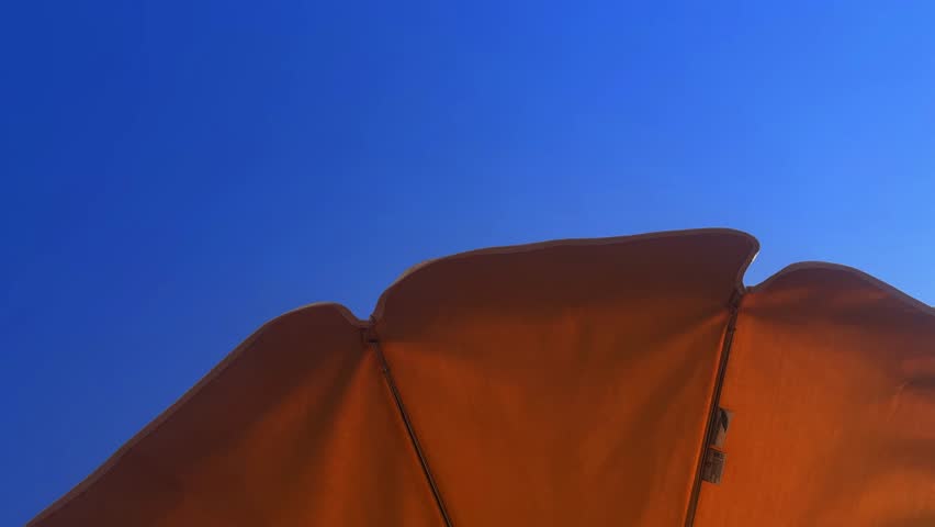 A closeup footage of an umbrella outdoors in blue sky background in Tenerife, Spain