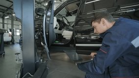 Mechanic Performing Car Diagnostics with Laptop - Powered by Shutterstock - Get 15% off with code: PIKWIZARD15