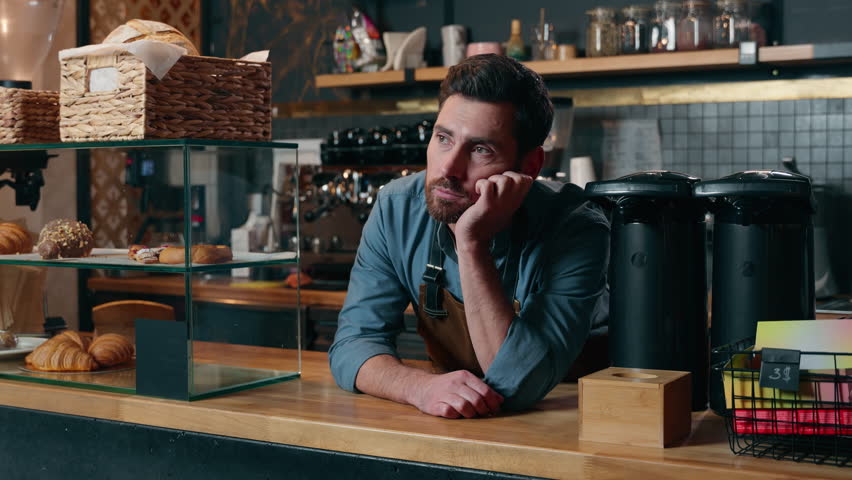 Tired bored Caucasian male entrepreneur cafeteria worker man feel exhausted sad in coffee shop barista small business owner problem no clients restaurant crisis upset waiter guy waiting for customers