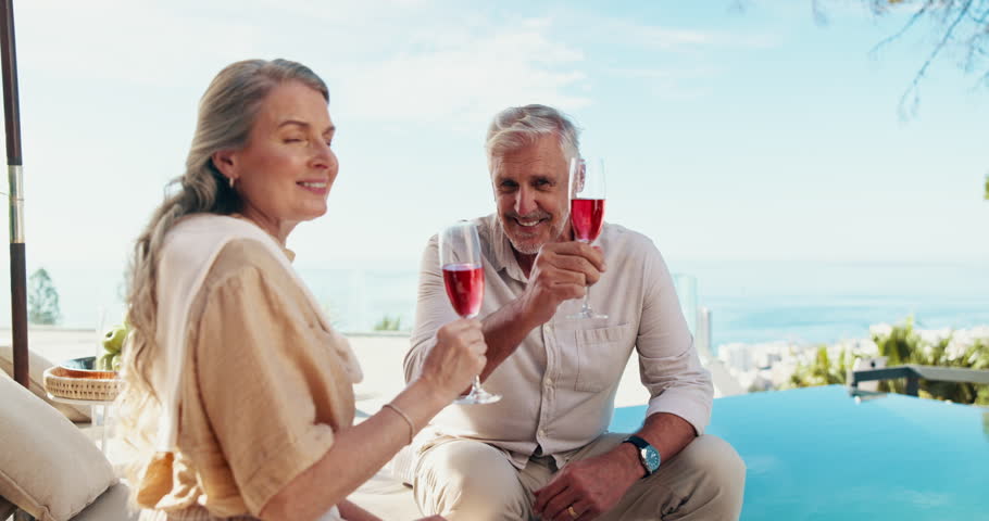 Couple, face and cheers with drinks by swimming pool on holiday, vacation or valentines day. Toast, senior man and woman with alcohol at resort outdoor for love, happy or relax in retirement in USA