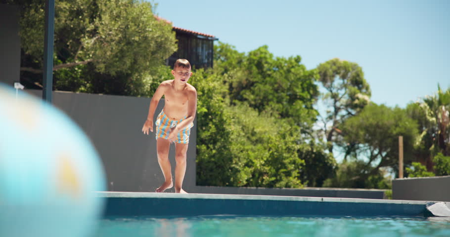 Holiday, child running and jump in swimming pool for vacation, relax or travel to play at resort outdoor. Boy, kid and swimmer dive in water for summer tourism, learning or splash for energy at hotel
