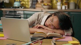 Tired exhausted insomnia Indian Arabian sleeping girl student high school university home education sleep on kitchen table woman female pupil napping sleep lying books boring studying fatigue homework - Powered by Shutterstock - Get 15% off with code: PIKWIZARD15