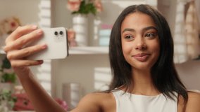 Hispanic latino woman beauty blogger model influencer selfie photo mobile phone social media skincare blog vlog beautiful happy ethnic girl posing in bathroom face makeup cosmetics video smartphone - Powered by Shutterstock - Get 15% off with code: PIKWIZARD15