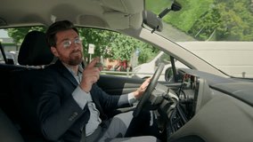 Caucasian male businessman driver in own car sing listen music radio happy man driving automobile travel road city carefree cheerful guy drive rent buy modern electric transport singing at camera fun - Powered by Shutterstock - Get 15% off with code: PIKWIZARD15